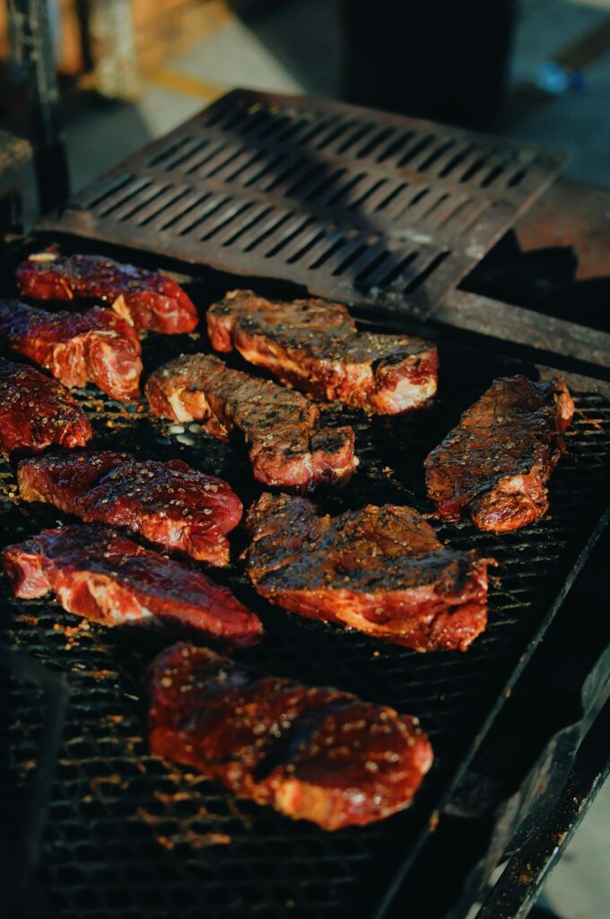 pexels-photo-2491273-2491273 Sizzling steaks on a charcoal grill, perfect for a backyard BBQ.